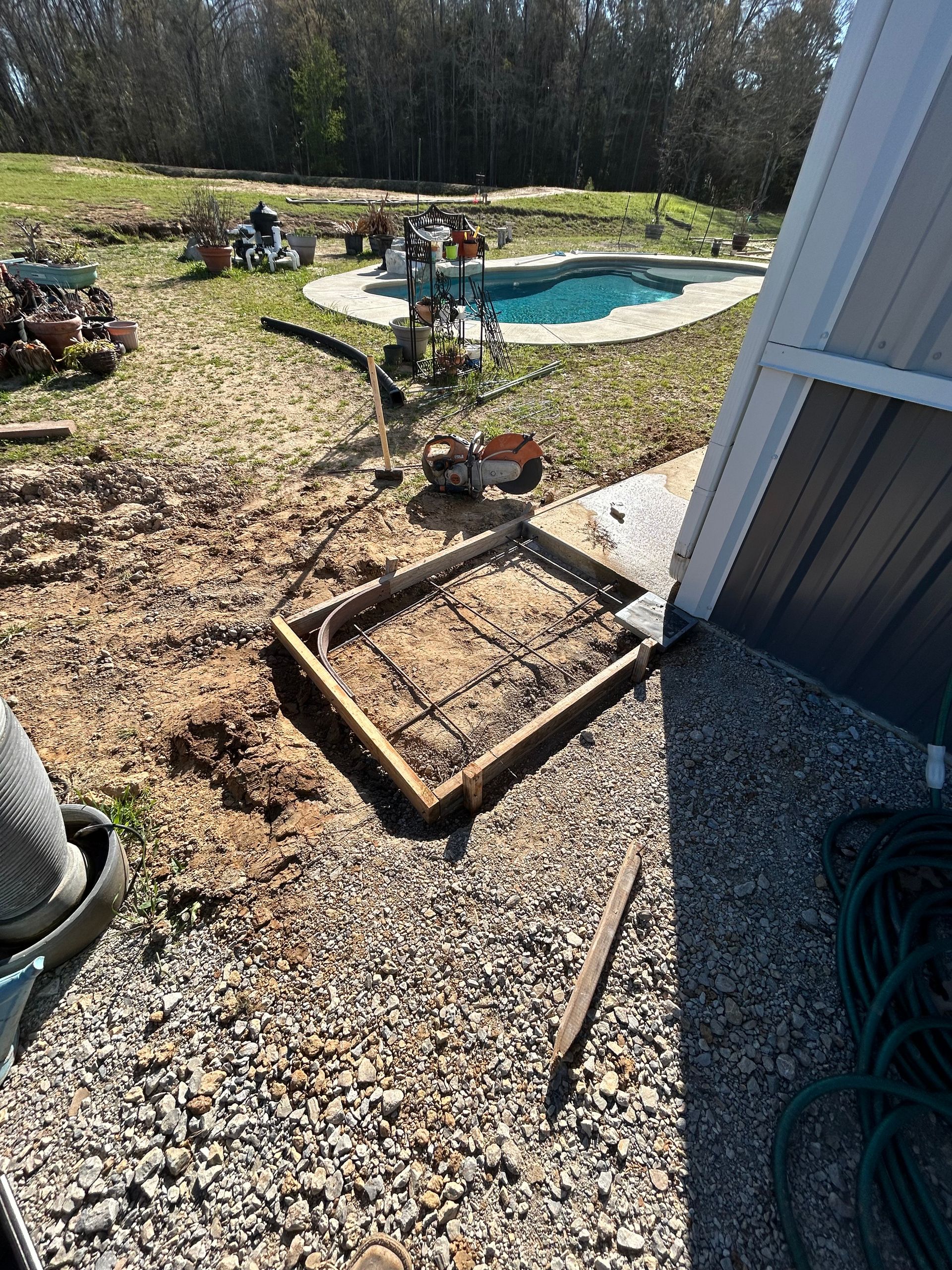 A shed is being built in a backyard next to a pool.