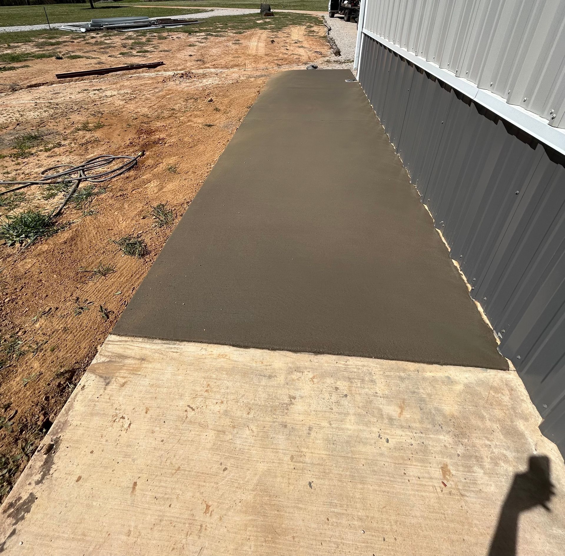 A sidewalk is being built in front of a building