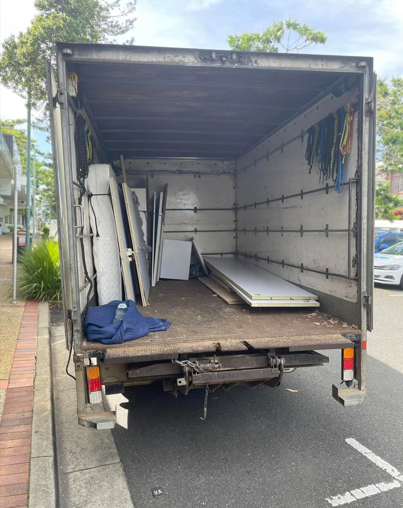 A Truck Is Parked On The Side Of The Road With The Back Door Open — Easy Flow Removals In Laurieton, NSW