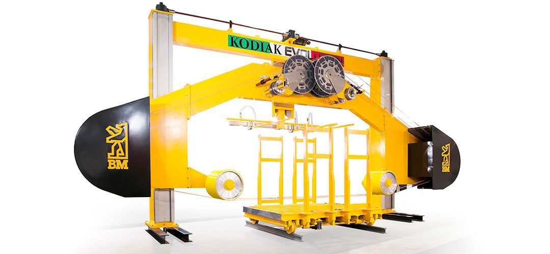 A yellow and black machine is sitting on a white surface.