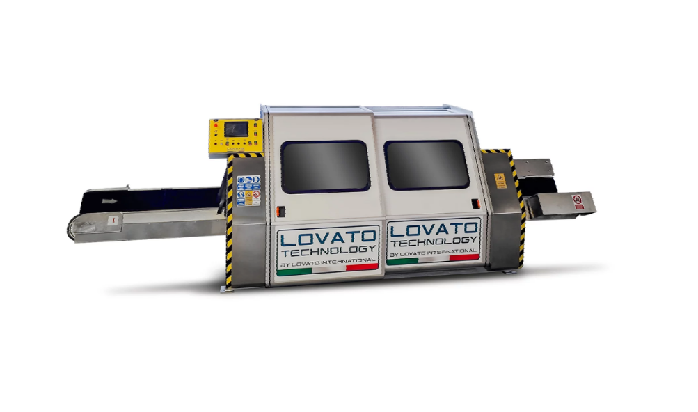 A stainless steel machine is sitting on a white surface.