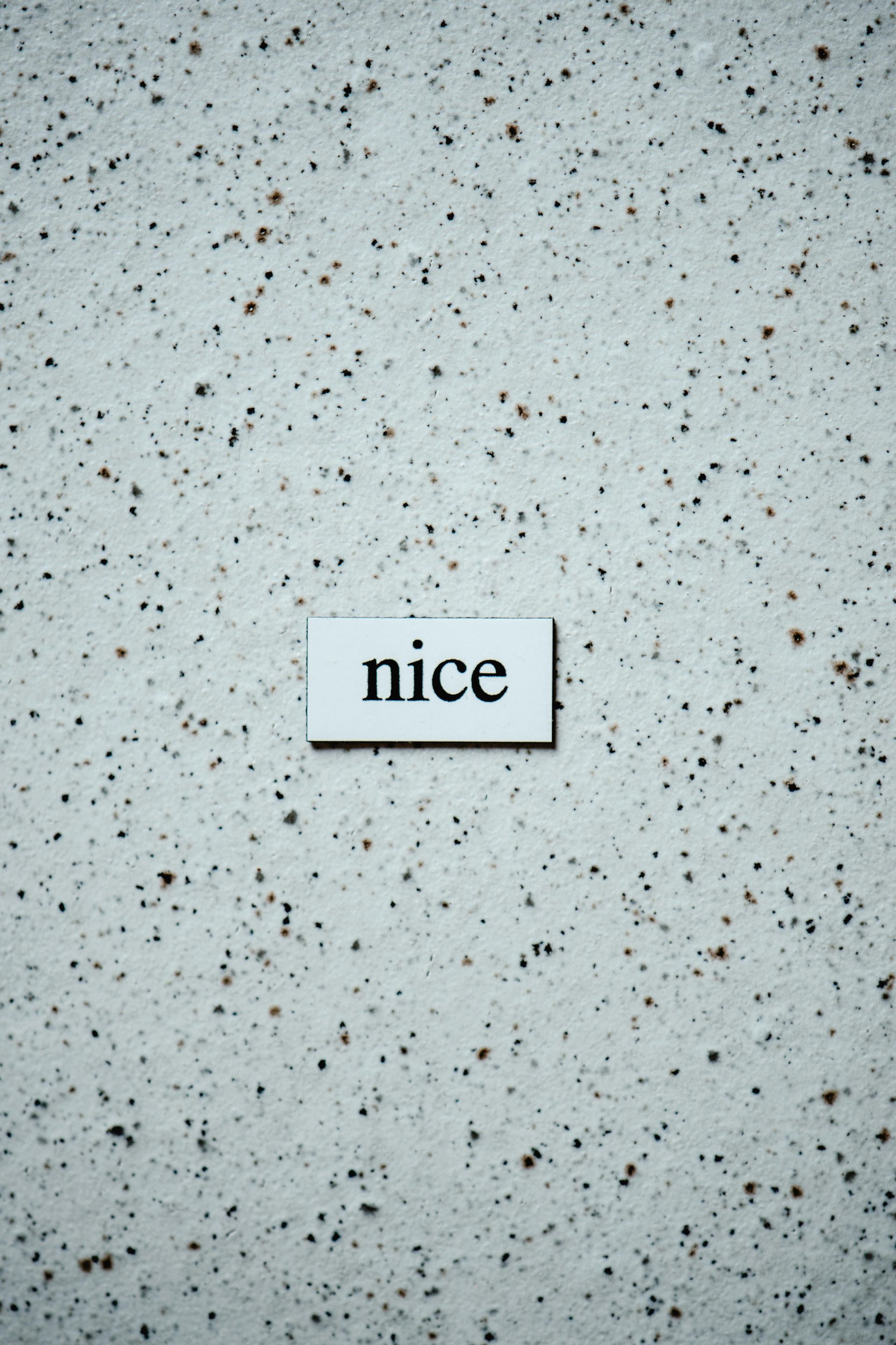 A piece of paper with the word nice on it