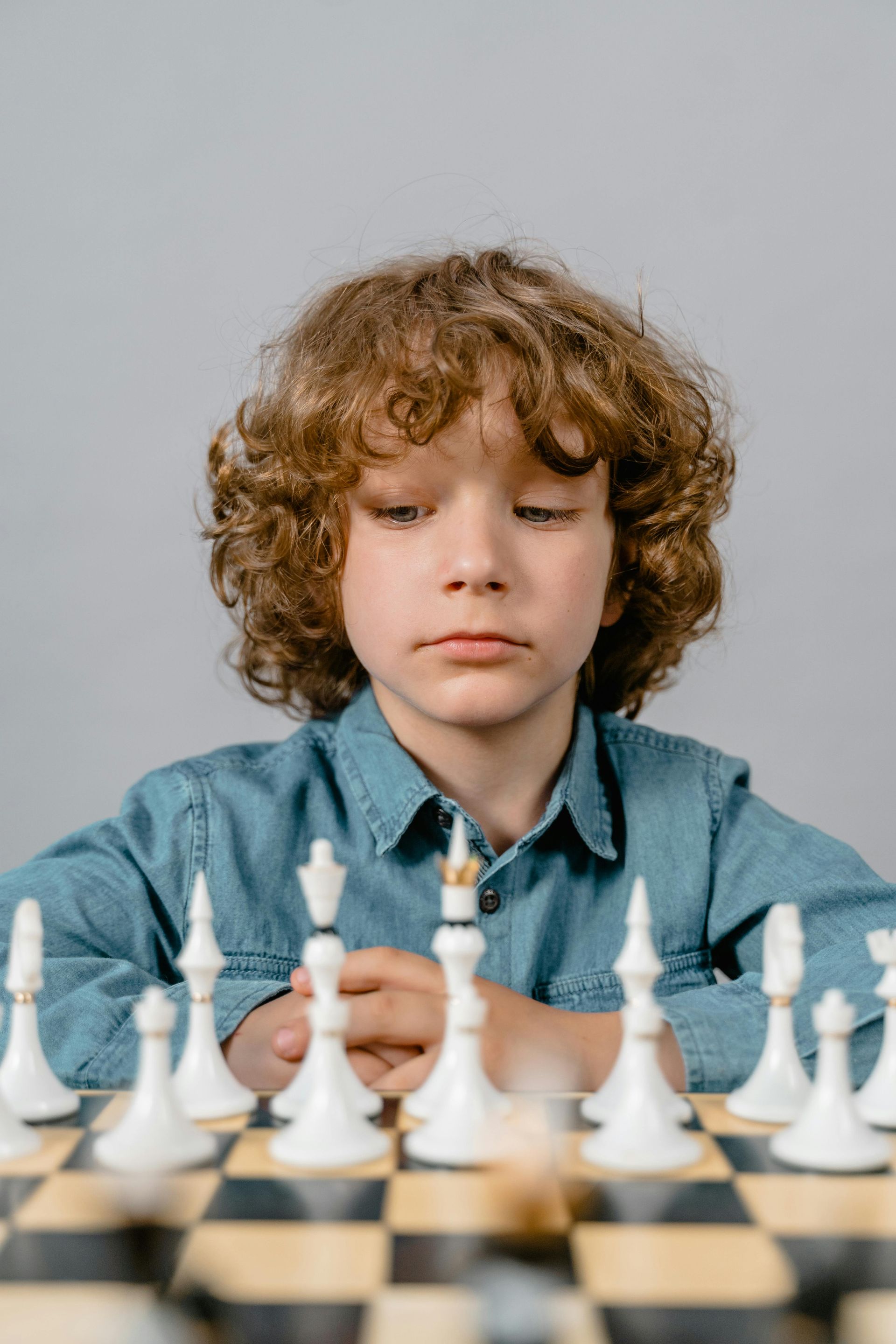 A young boy is playing a game of chess.