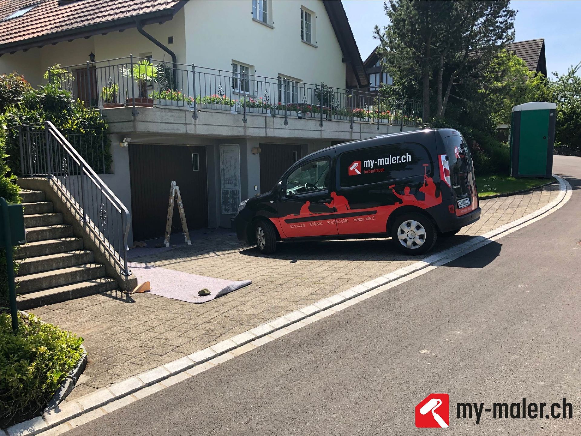 Ein Lieferwagen steht vor einem Haus am Strassenrand.