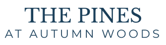 The Pines at Autumn Woods: Dark blue text on a white background.