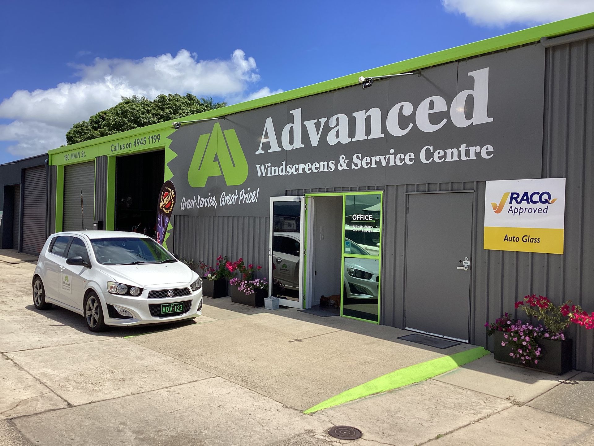 A Close Up Of A Building With A Car — Advanced Windscreens & Service Centre In Whitsunday Region, QLD