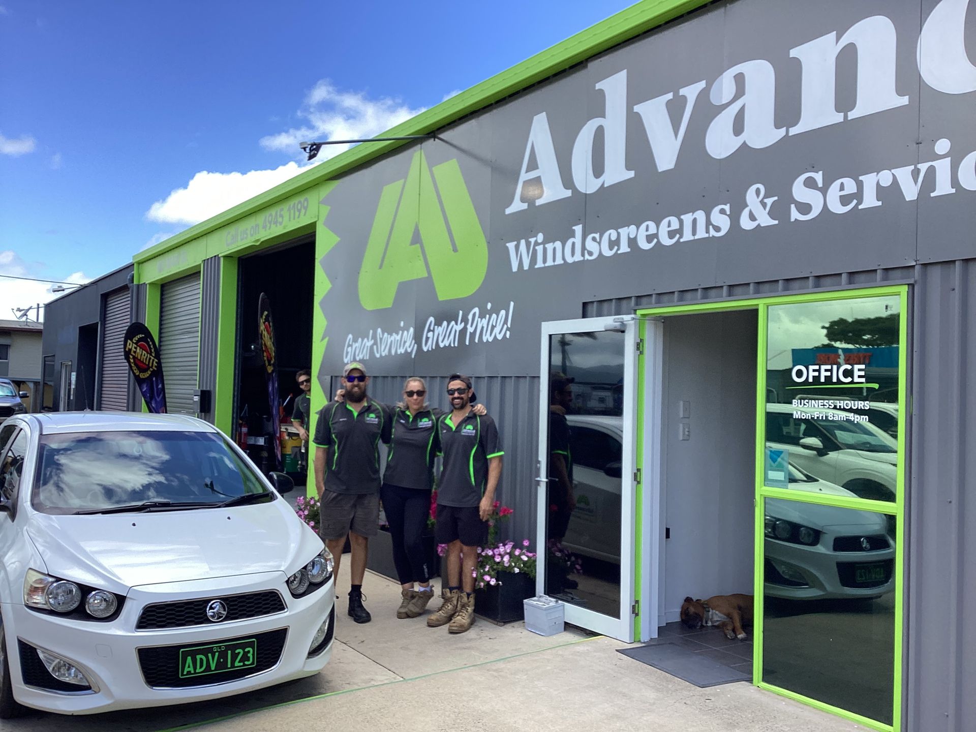Three People Are Standing Outside Of A Building— Advanced Windscreens & Service Centre In Whitsunday Region, QLD