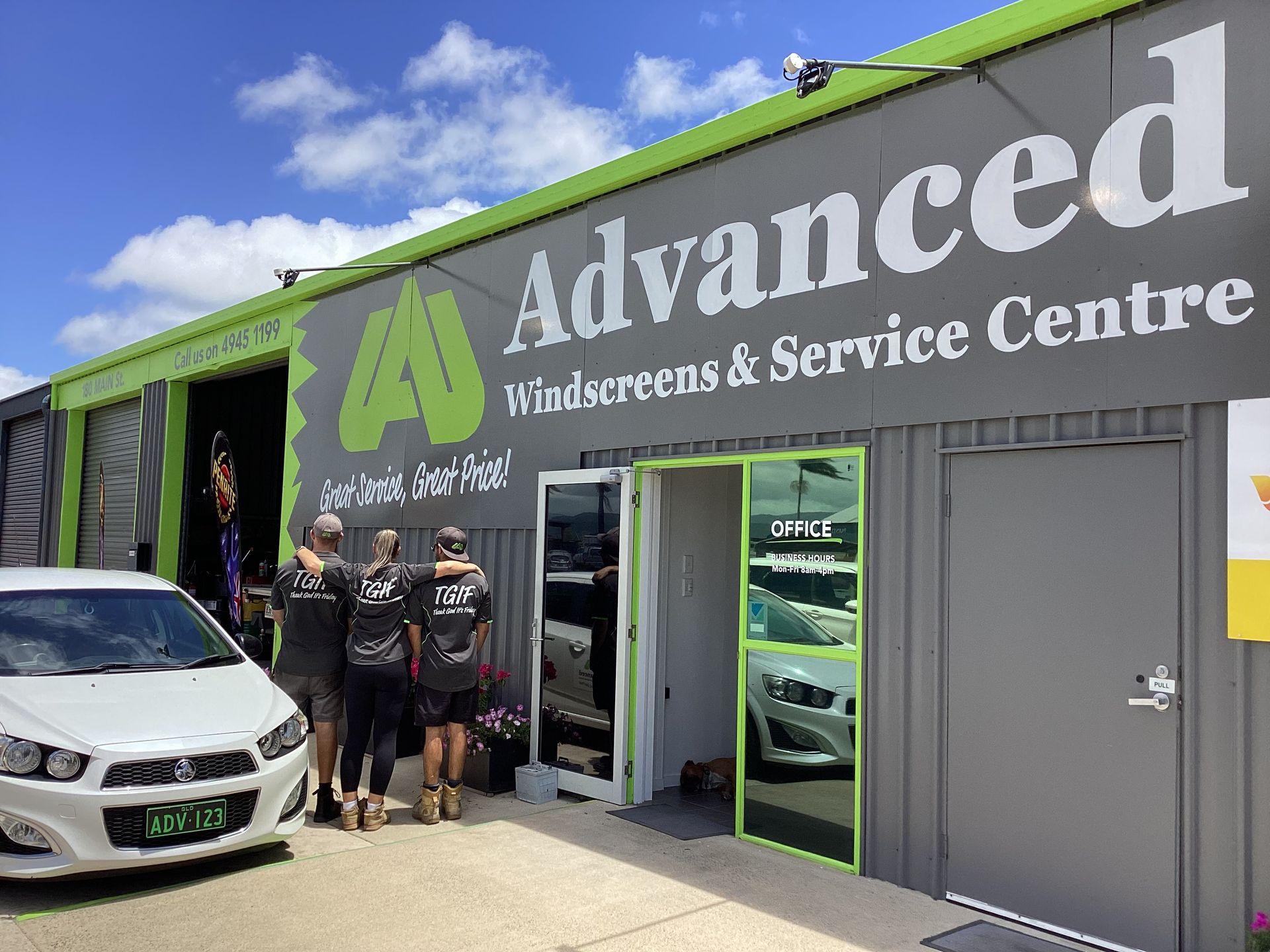 Three People Are Standing In Front Of A Garage With Their Backs Facing Out — Advanced Windscreens & Service Centre In Proserpine, QLD