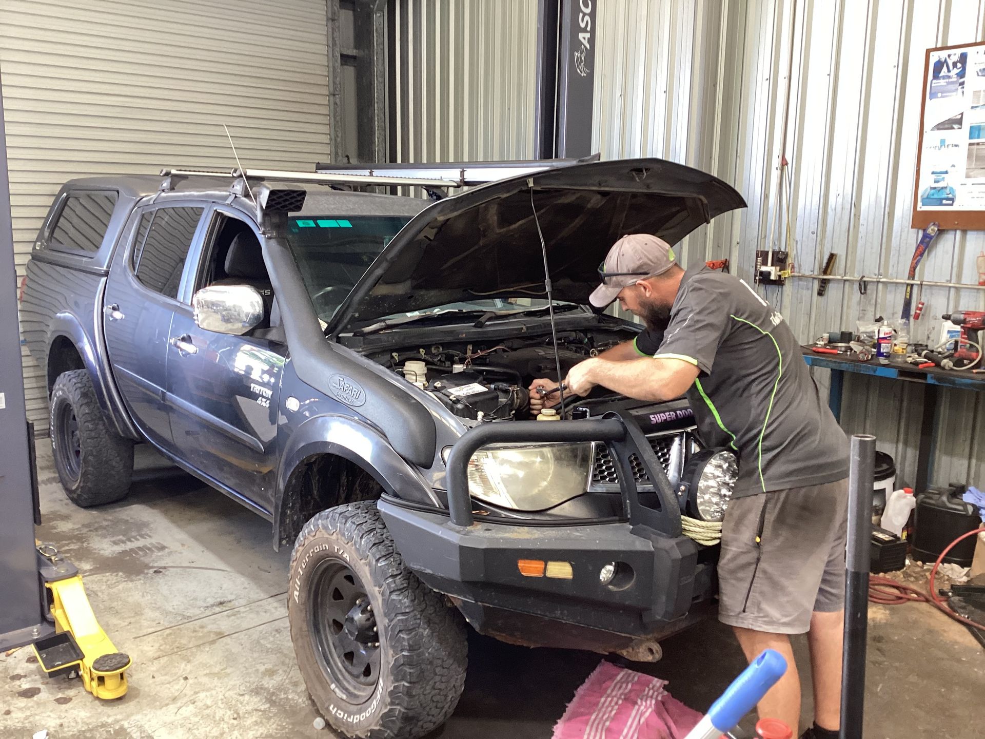 A Red Car With The Hood Up Is Parked In A Garage — Advanced Windscreens & Service Centre In Proserpine, QLD