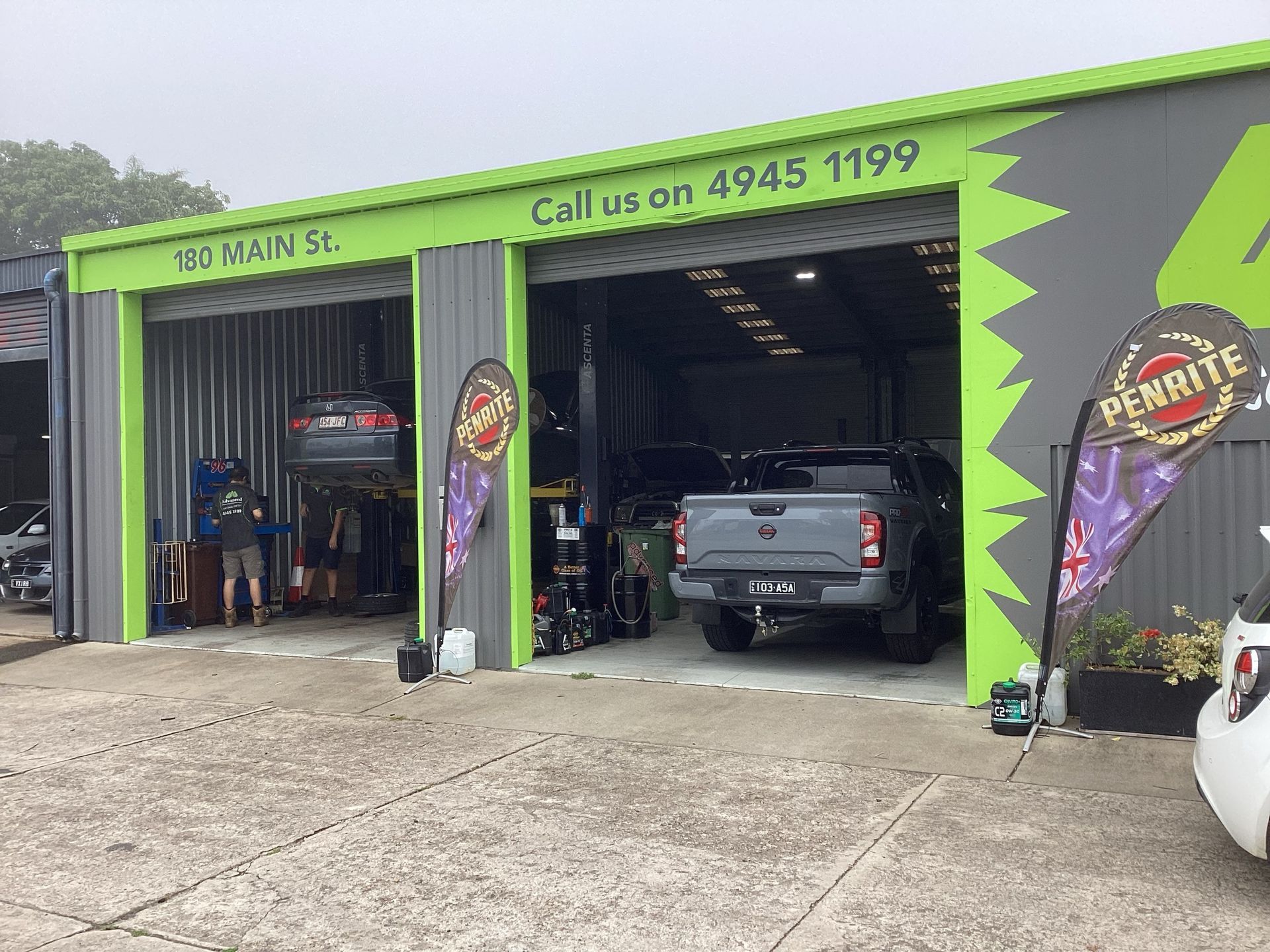 Two cars are parked in of a car servicing centre — Advanced Windscreens & Service Centre In Whitsunday Region, QLD