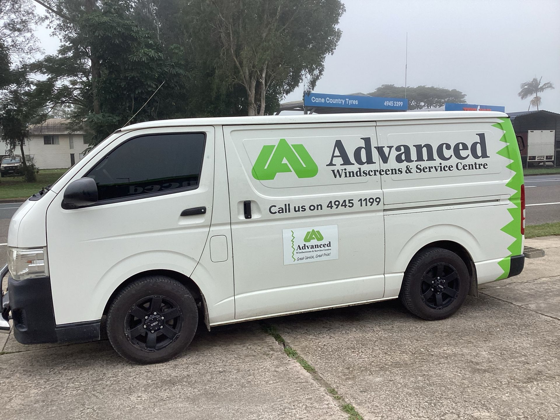 A white van with the word advanced on it is parked on the side of the road — Advanced Windscreens & Service Centre In Whitsunday Region, QLD