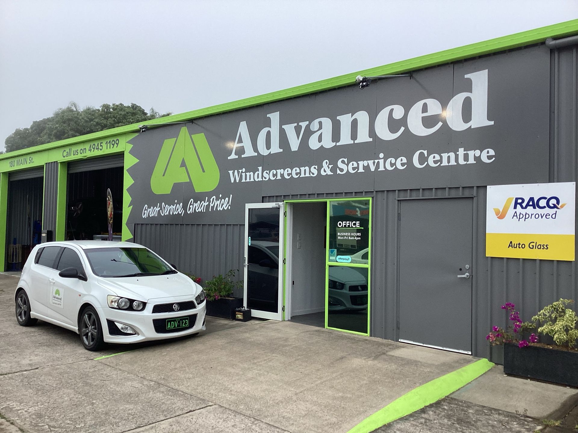 A white car is parked in front of an advanced windscreens and service centre — Advanced Windscreens & Service Centre In Proserpine, QLD