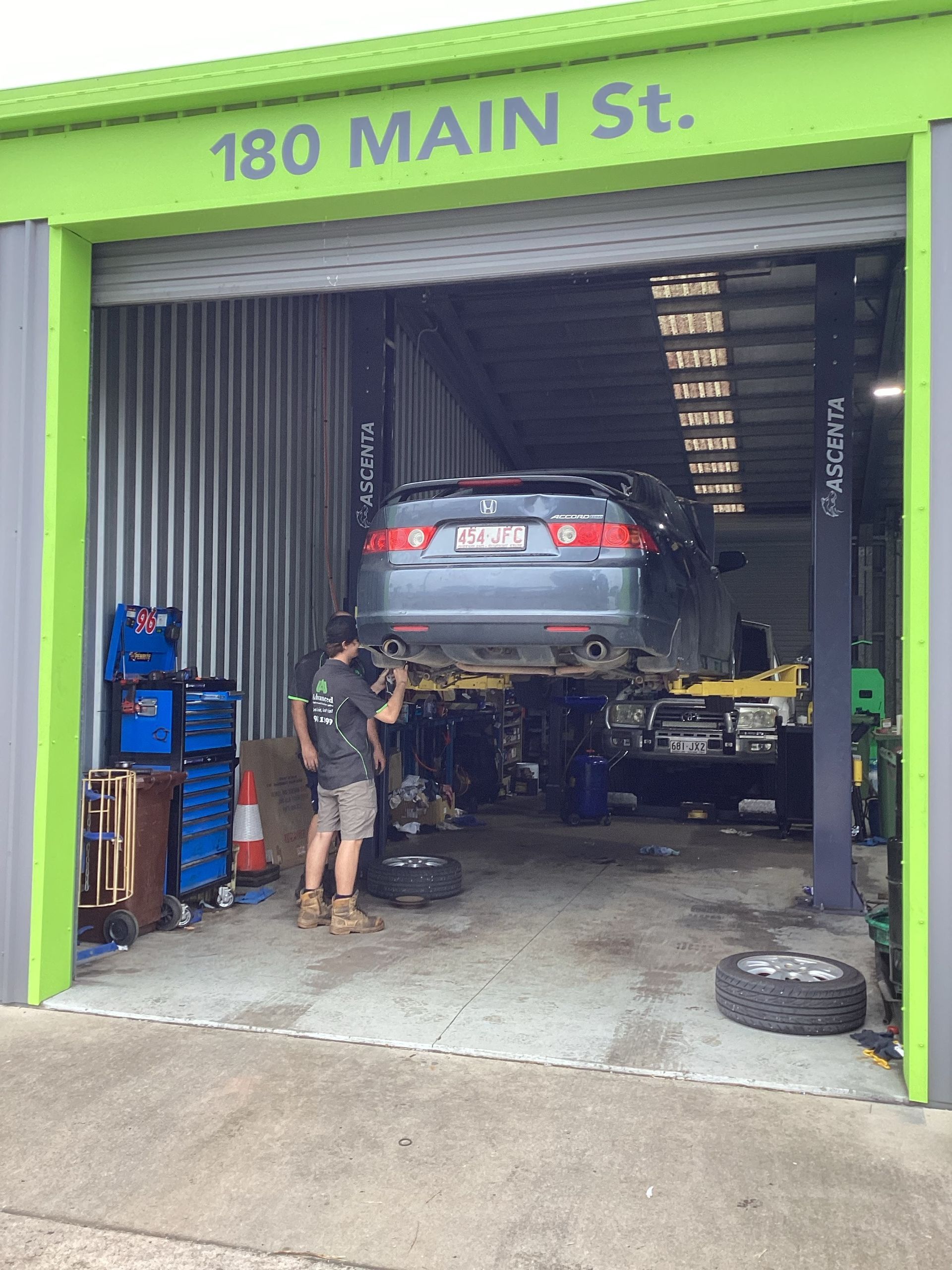 A man is working on a car in a garage — Advanced Windscreens & Service Centre In Proserpine, QLD