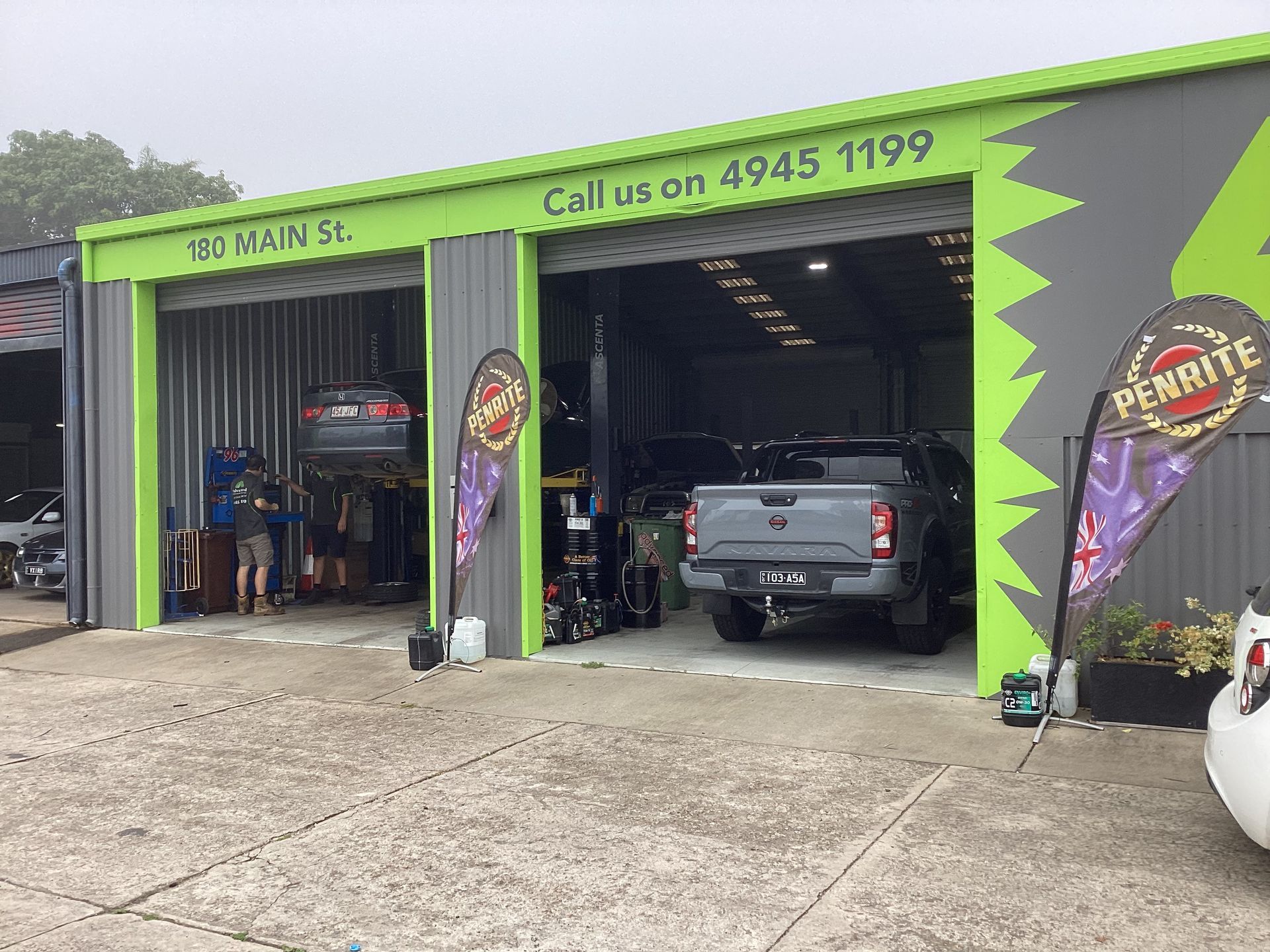 A man is working on the engine of a truck in a garage — Advanced Windscreens & Service Centre In Proserpine, QLD