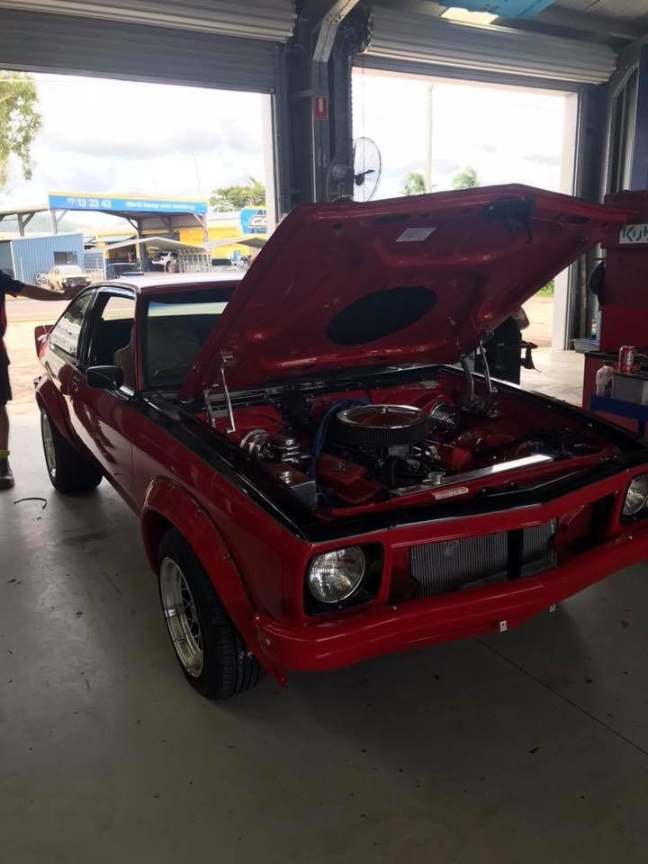 A Red Car With The Hood Up In A Garage — Advanced Windscreens & Service Centre In Proserpine, QLD
