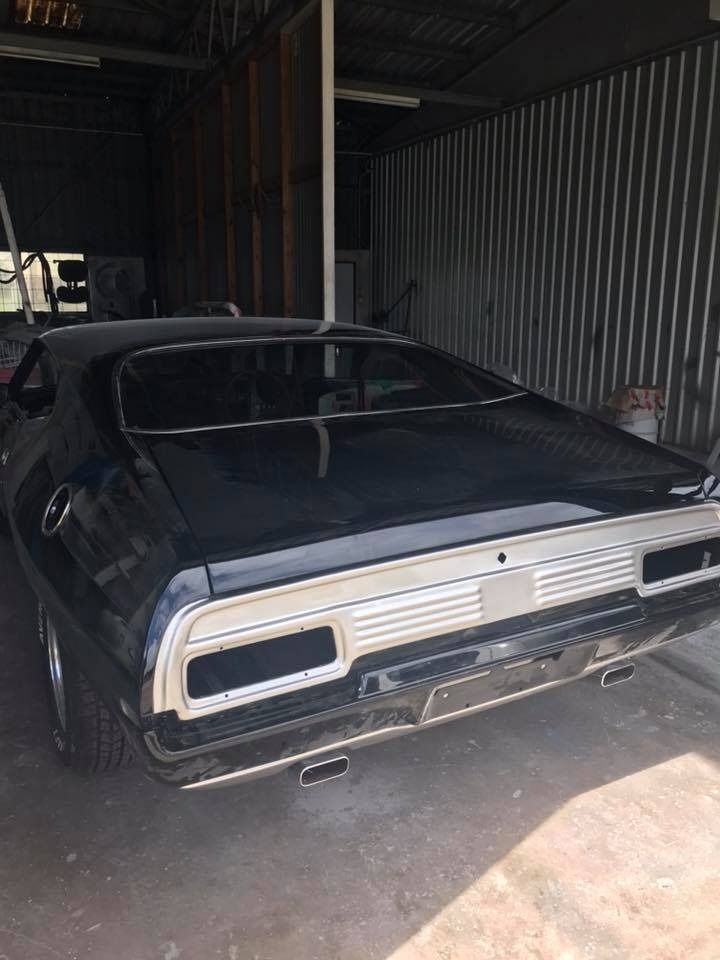 A Black Car Is Parked In A Garage — Advanced Windscreens & Service Centre In Proserpine, QLD