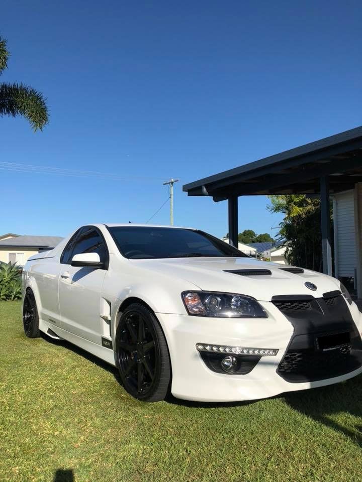 A White Sports Car Is Parked In Front Of A House — Advanced Windscreens & Service Centre In Bowen, QLD