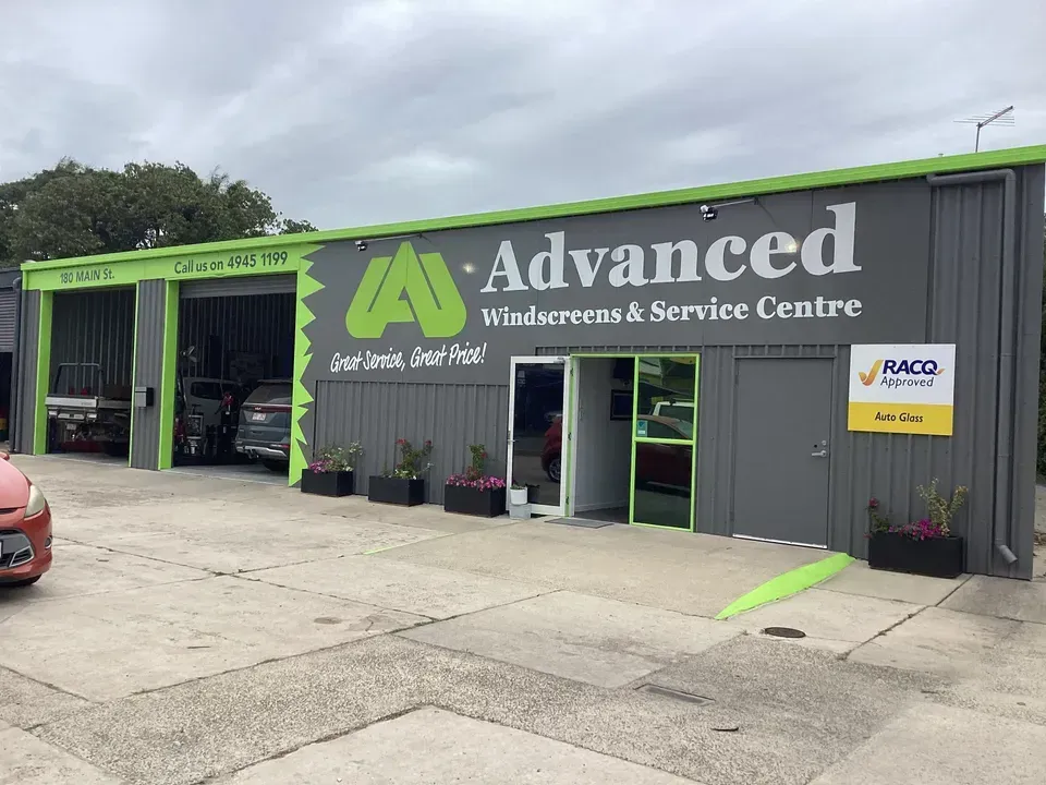 A White Van Is Parked In Front Of A Garage — Advanced Windscreens & Service Centre In Proserpine, QLD