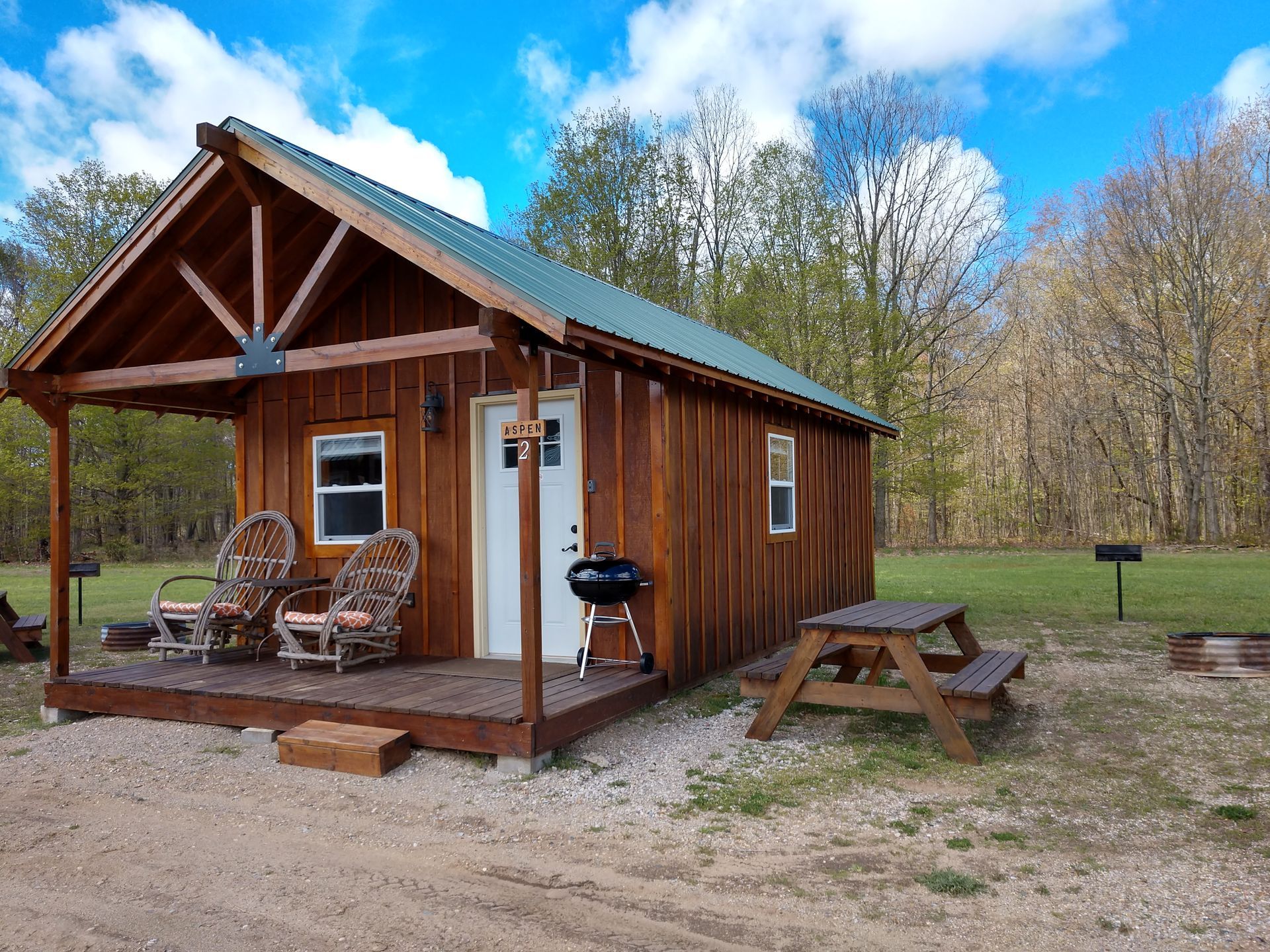 General view of our Family Cabins with 3 showing outdoor spaces and front porch.