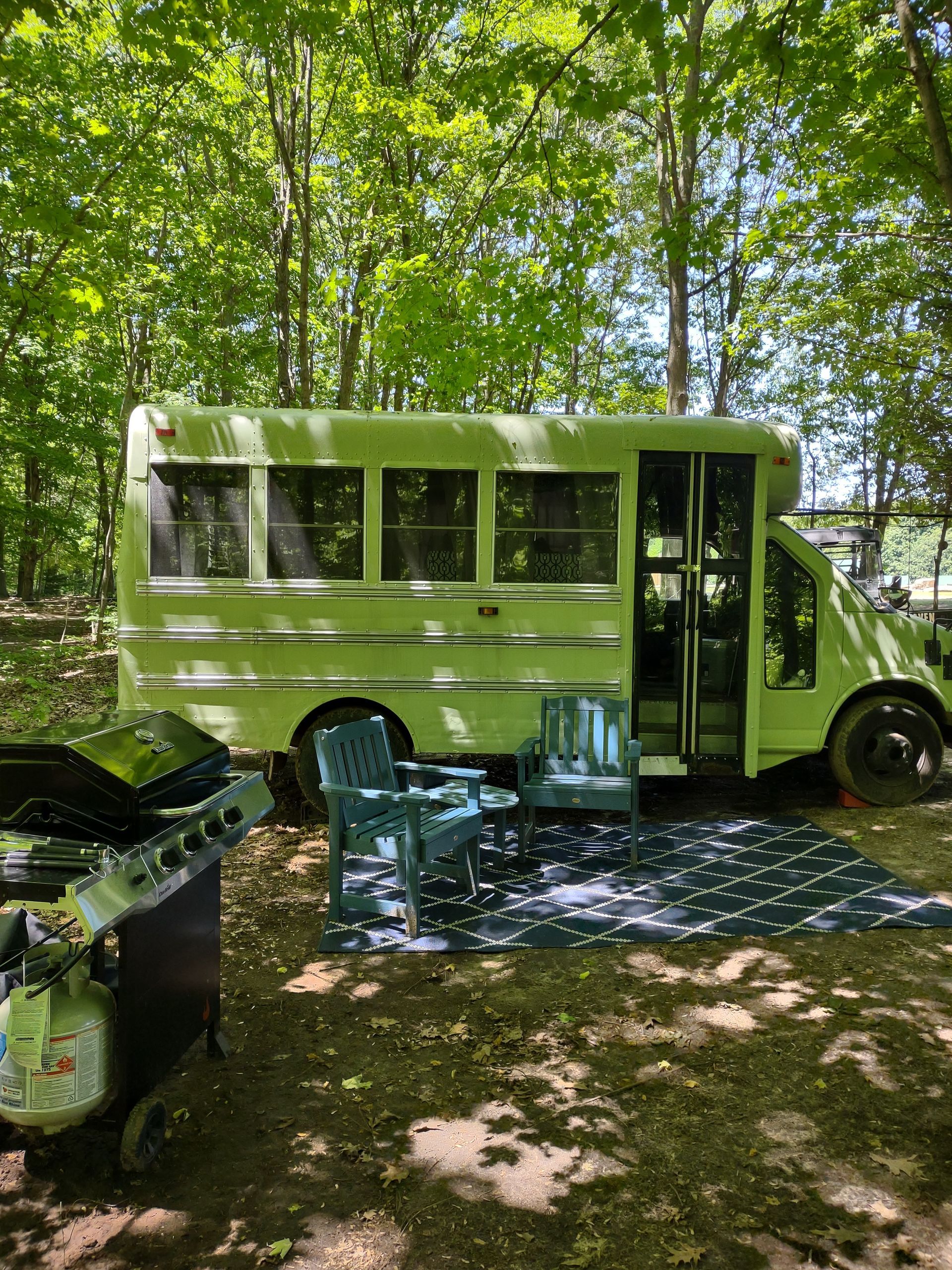 Main view of our Skoolie, a 22 passenger bus painted mint green and custom converted into a cozy camper.