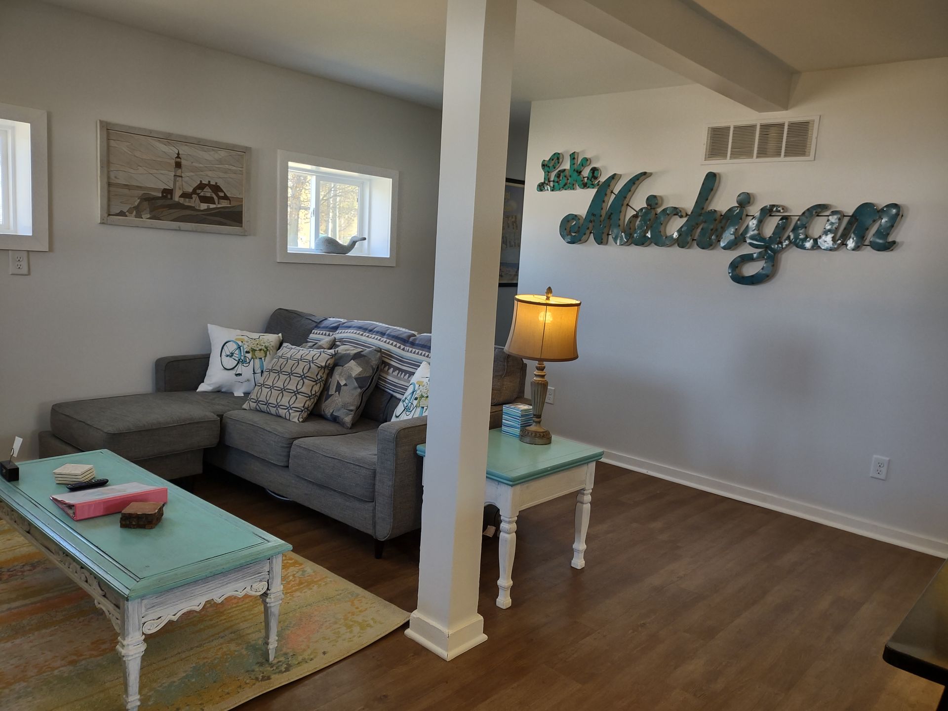 Livning room of Duplex West with Lake Michigan sign and couch