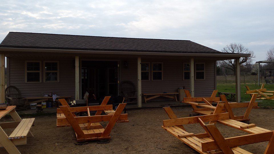 Picnic tablese being stained for campground.