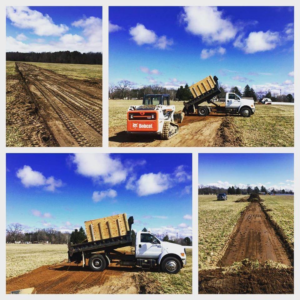 Road construction on the campground with dump truck and bobcat.