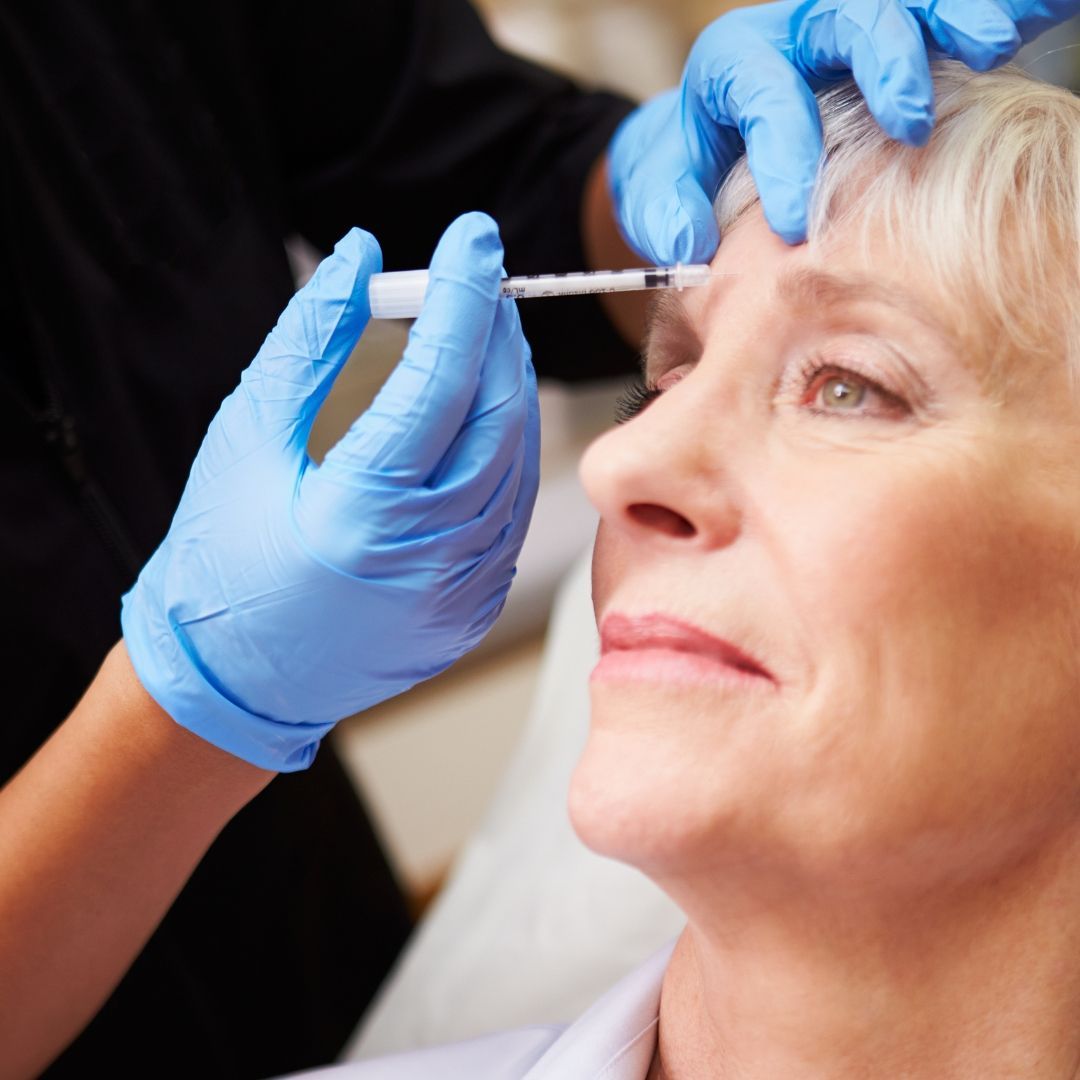 An older woman having antiwrinkle injections