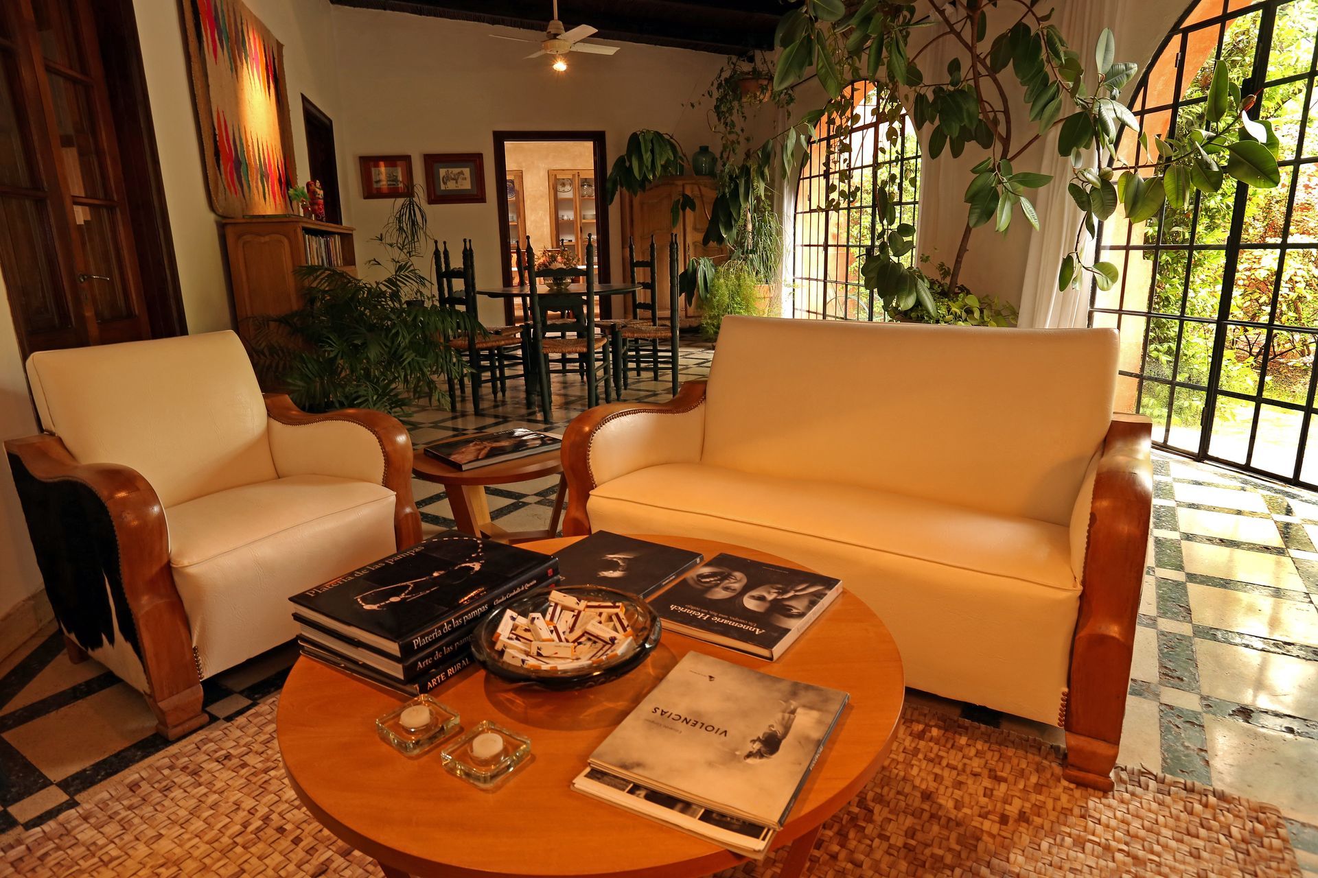 Chickens foraging for food among rows of grape vines in a vineyard. Green grass and foliage are visible.