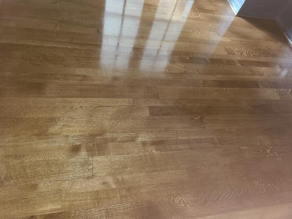 A close up of a wooden floor in a room.