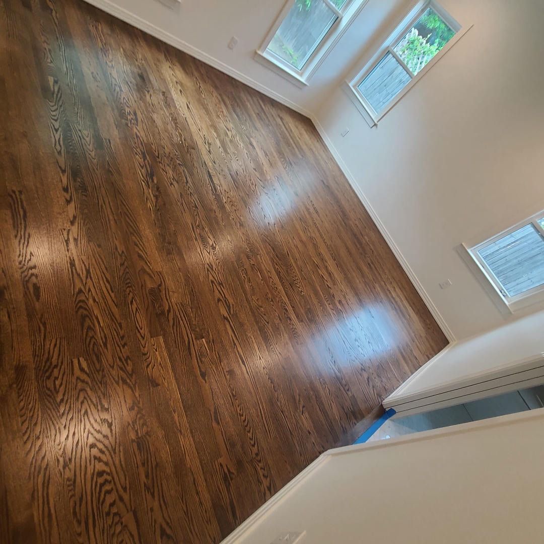 A room with hardwood floors and white walls.