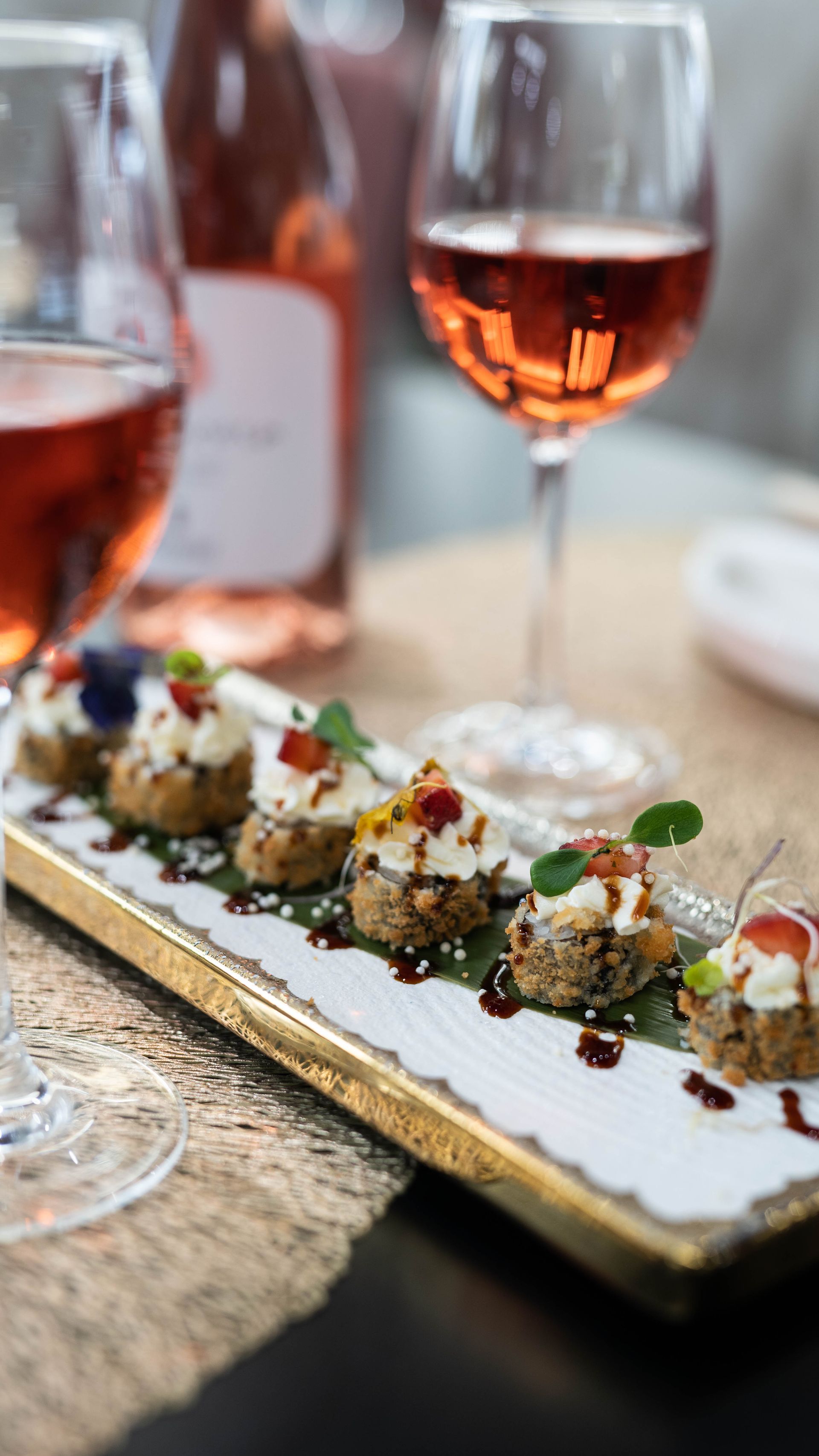 Un piatto di cibo e un bicchiere di vino su un tavolo.