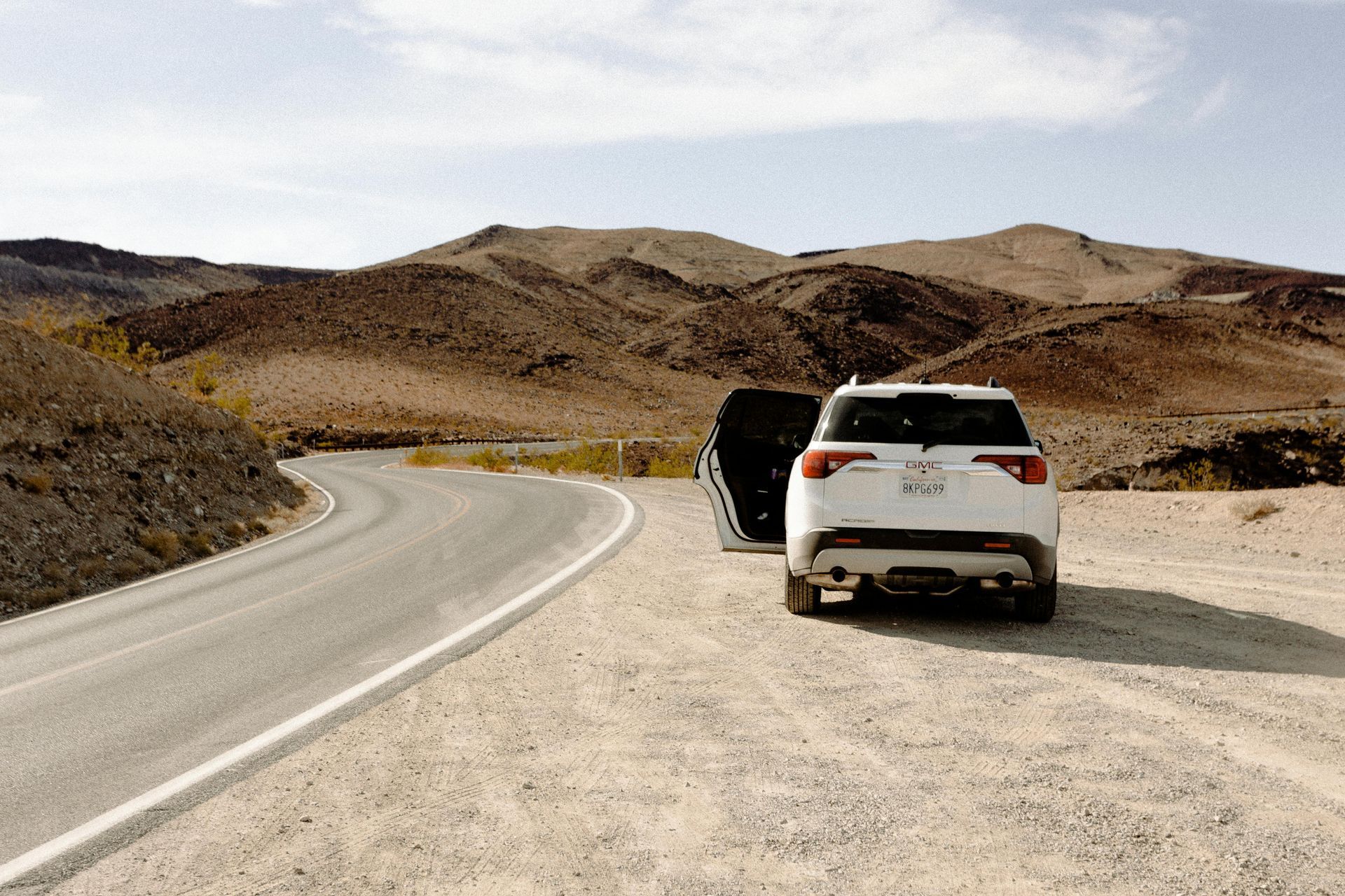 A white car is parked on the side of a dirt road.  | McInerney Auto Center