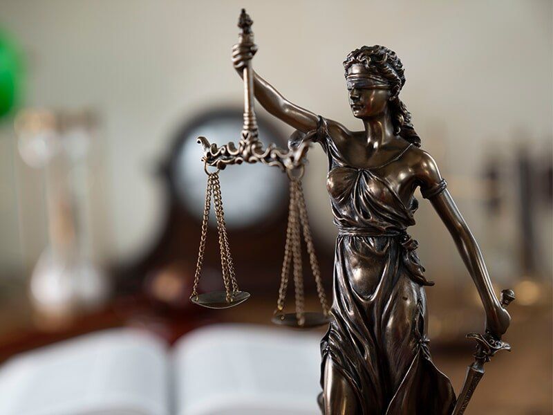 scales of justice being held by lady justice