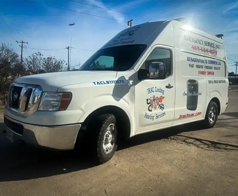 White van with company logo parked on a street, advertising septic tank services. Sunny day.