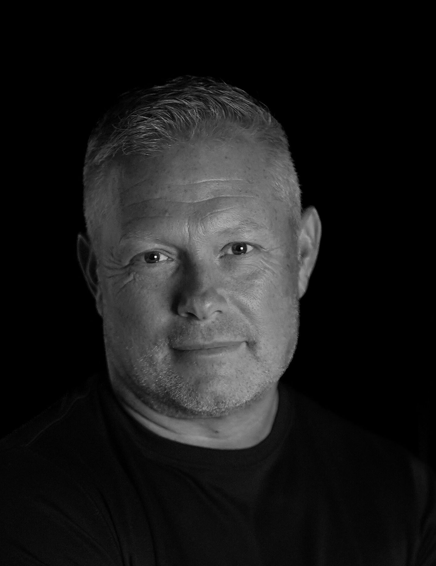A man in a suit and tie smiles for the camera