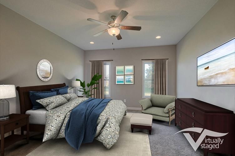 Bright bedroom with gray walls, blue bedding, ceiling fan, nightstands, and a dresser with wall art.