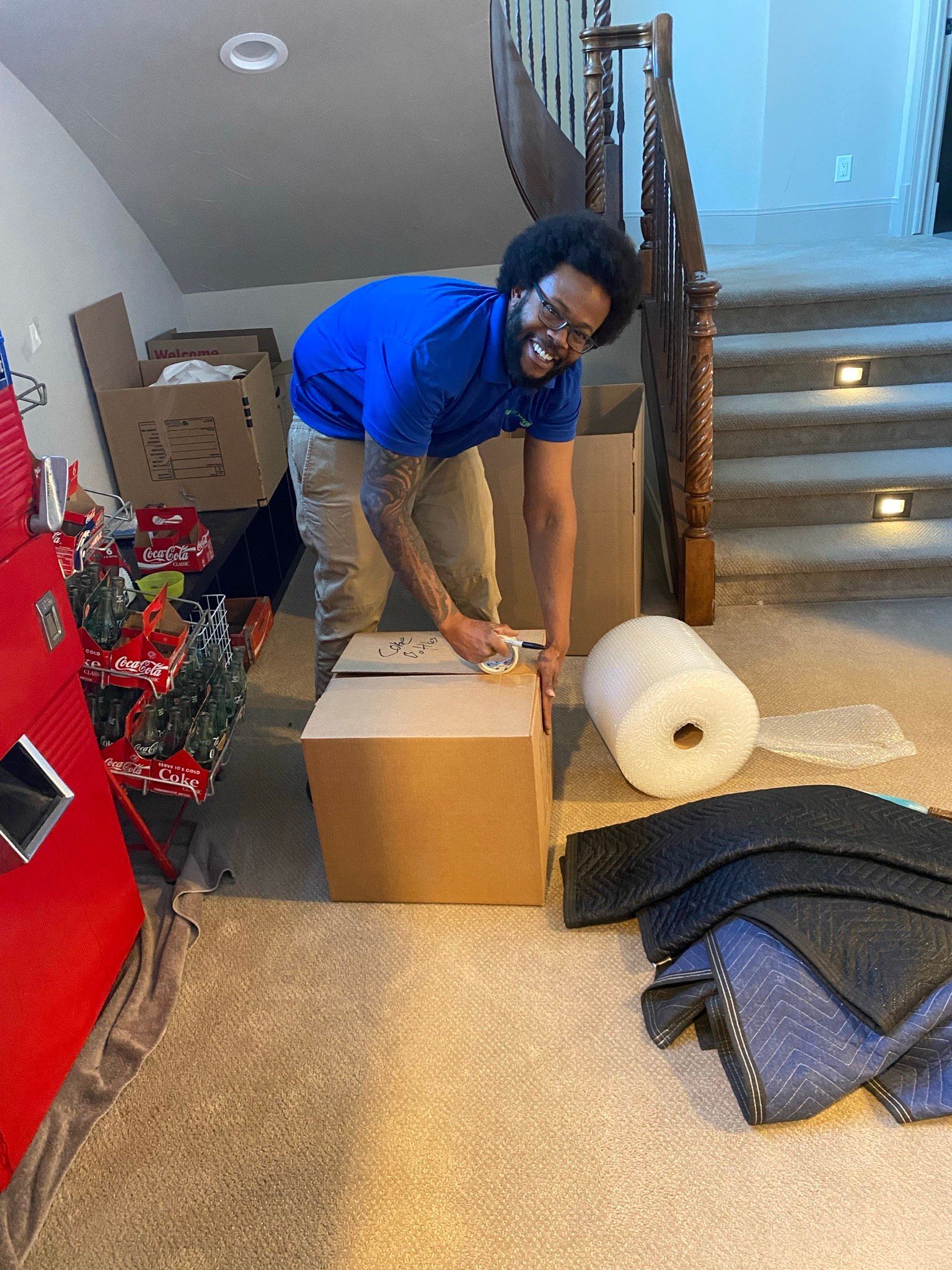 a man is packing a box in a living room .