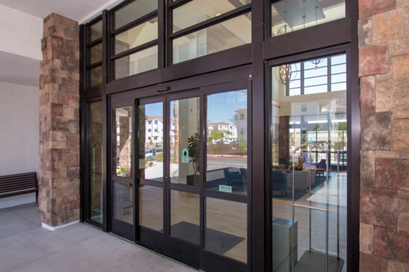 A large glass door in a building with a lot of windows.
