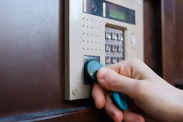 A person is using a key to open a door.