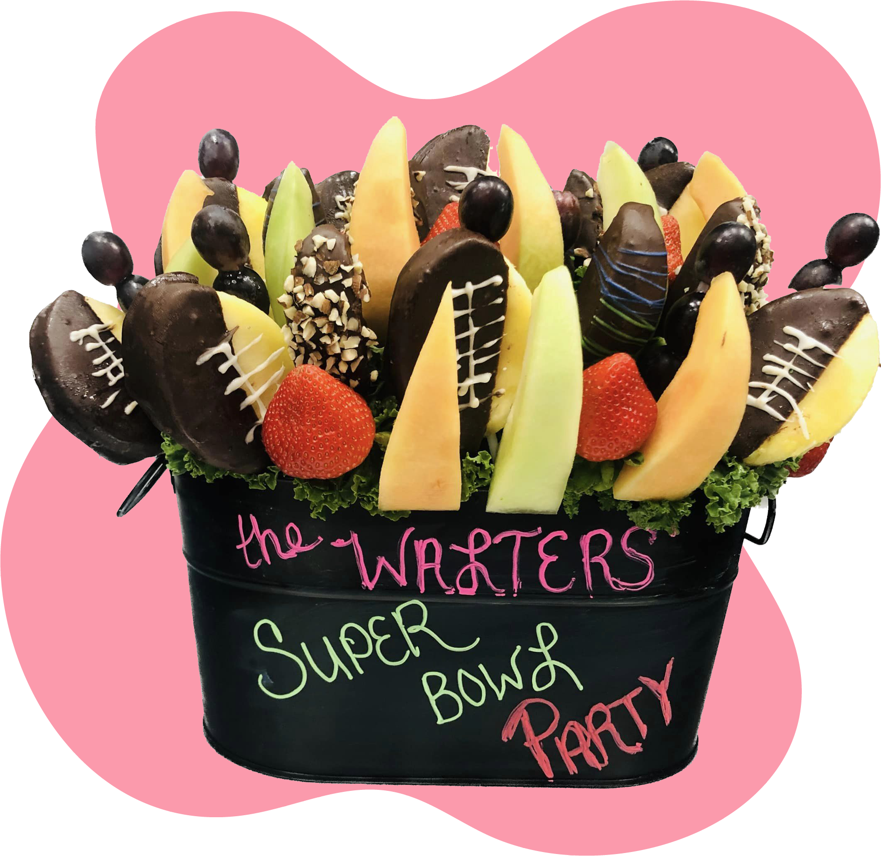 A bouquet of fruit in a bucket that says super bowl party
