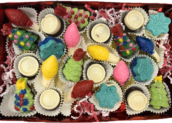 A skull shaped vase filled with strawberries and grapes