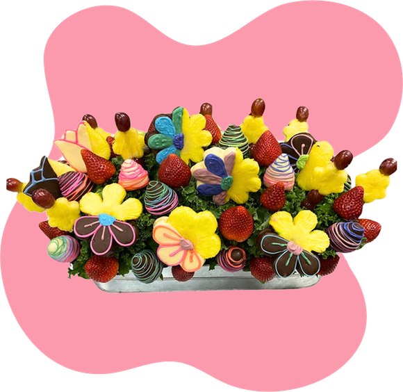 A bouquet of fruit and chocolate covered ghosts in a mug