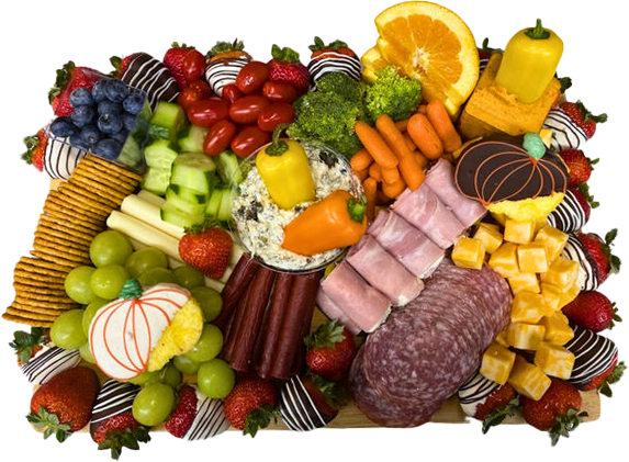 A skull shaped vase filled with strawberries and grapes