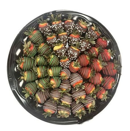 A black plate topped with chocolate covered strawberries on a white background.