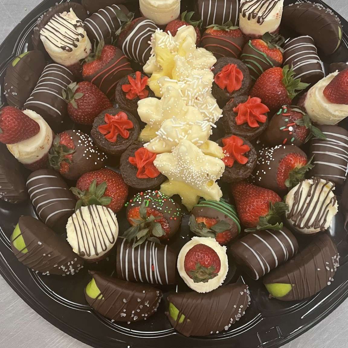 A tray filled with chocolate covered strawberries and bananas