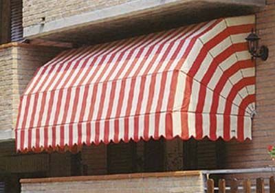 Red and white striped awning on a building, offering shade.