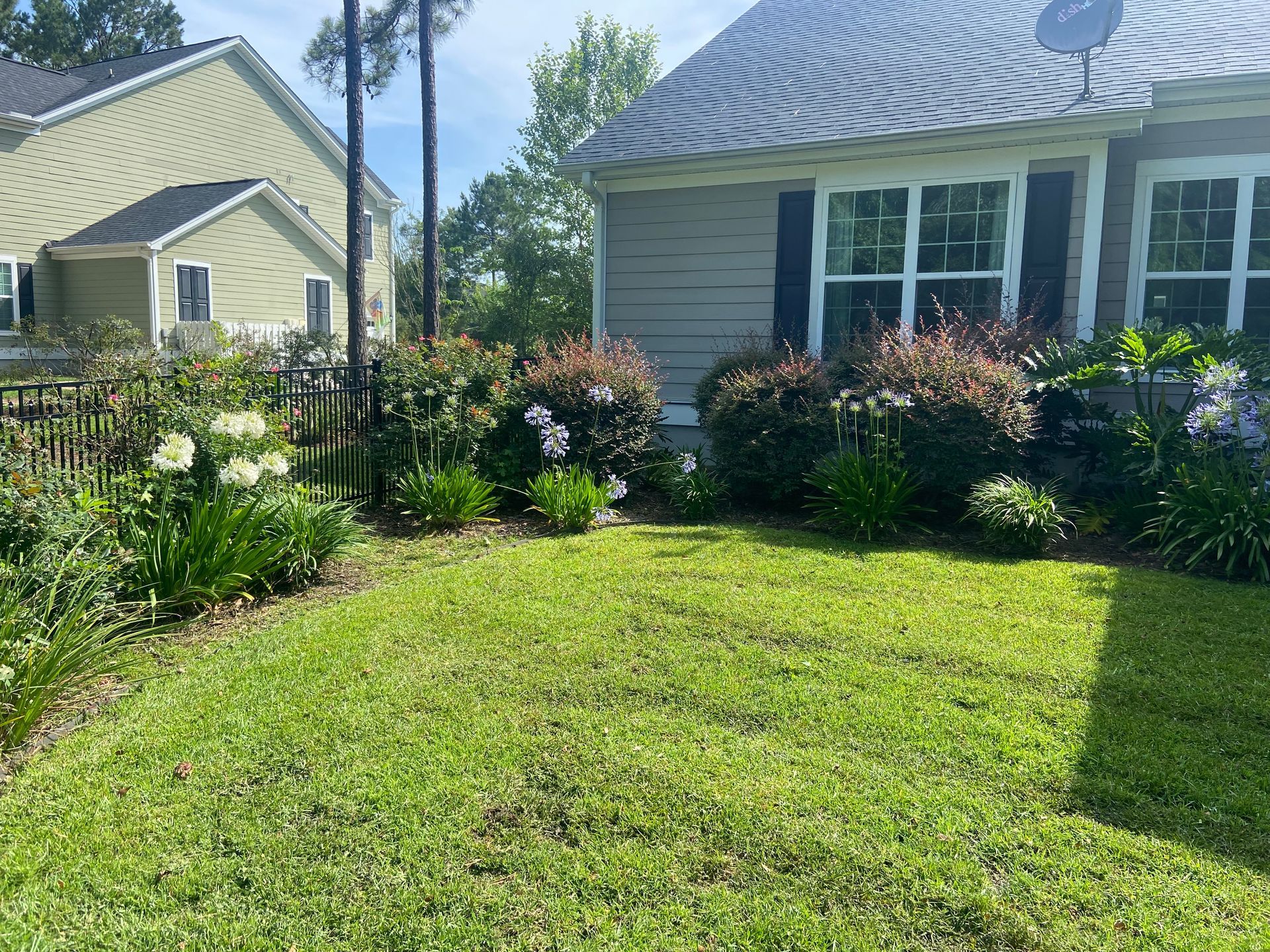 A house with a lush green lawn in front of it.