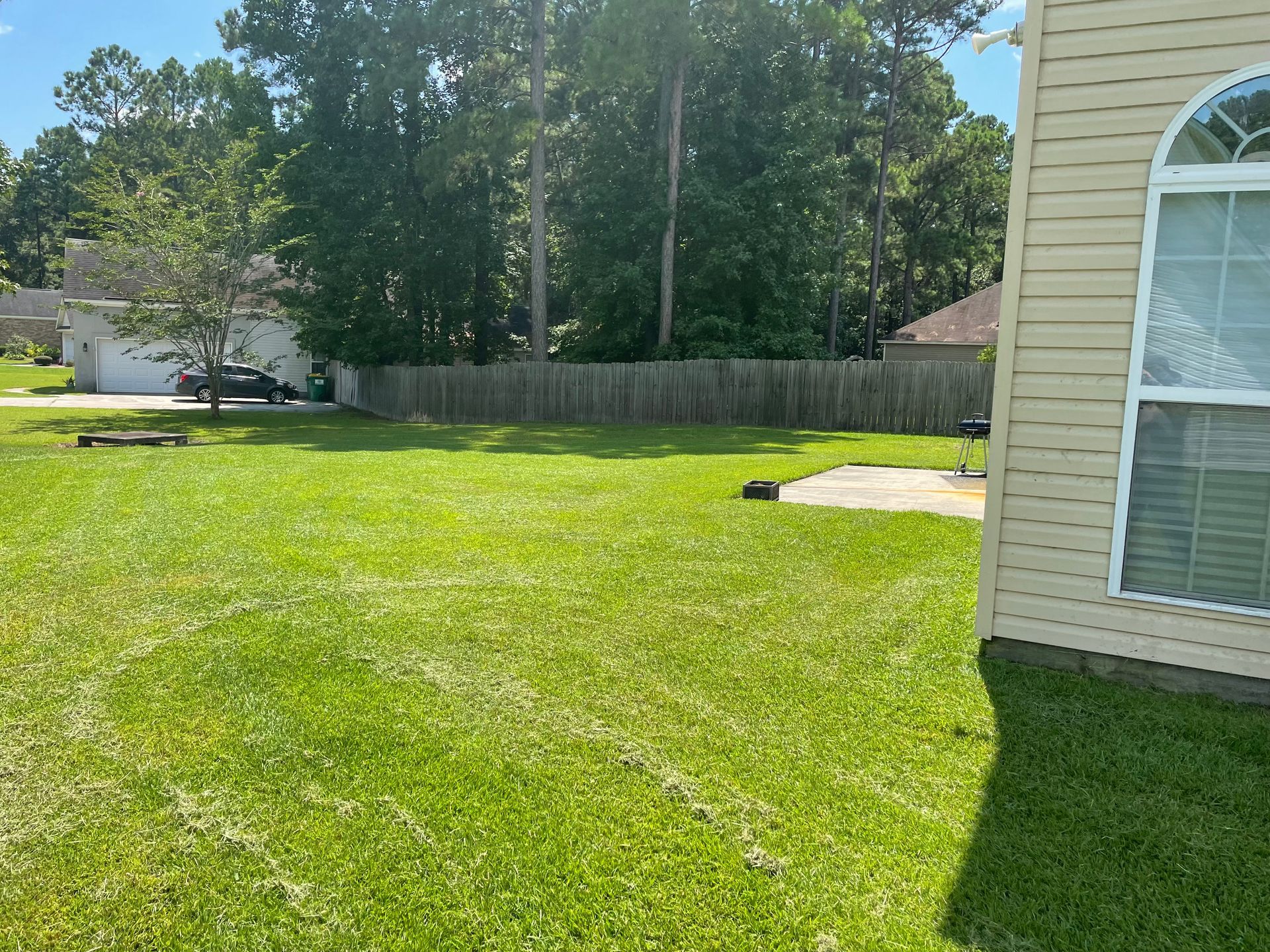 A house with a large lawn in front of it.