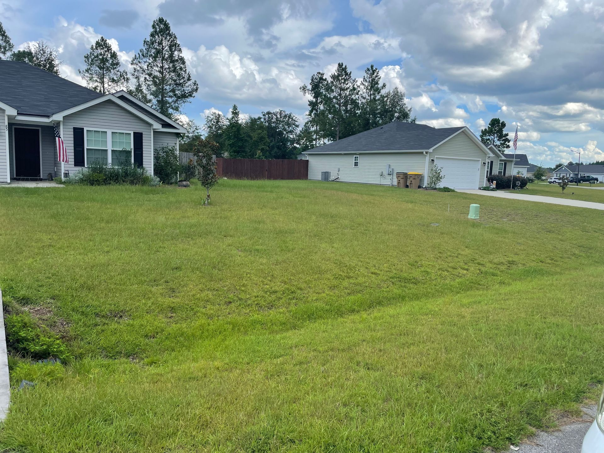 A house with a large lawn in front of it.